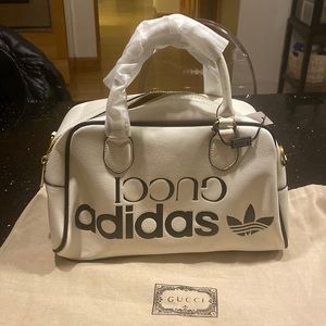 White leather with black trim. 12.5” x 8” x 6”.